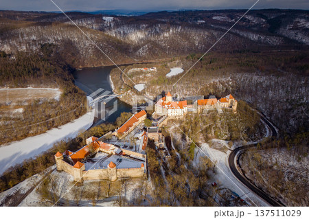 Beautiful old castle - top view from a drone. Winter landscape at sunset. Veveri Castle - City of Brno - Czech Republic - Europe. Beautiful old castle - top view from a drone. Winter landscape at sunset. Veveri Castle - City of Brno - Czech Republic - Europe. 137511029