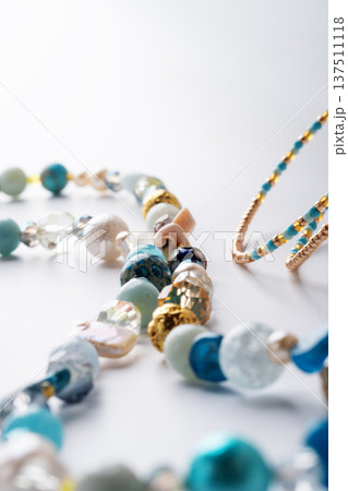 author trend necklace with different  beads  demonstrated  against white background. fashion and jewelry concept 137511118