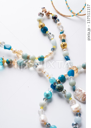 author trend necklace with different  beads  demonstrated  against white background. fashion and jewelry concept 137511157