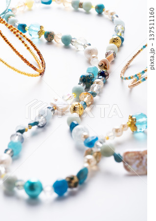 author trend necklace with different beads demonstrated against white background. fashion and jewelry concept author trend necklace with different beads demonstrated against white background. fashion and jewelry concept 137511160