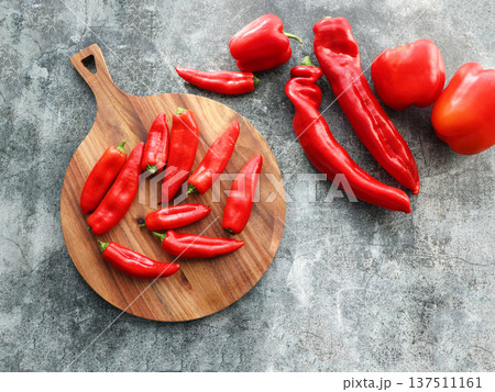 Fresh Red Bell and Chili Peppers on a Rustic Grey Background Fresh Red Bell and Chili Peppers on a Rustic Grey Background 137511161