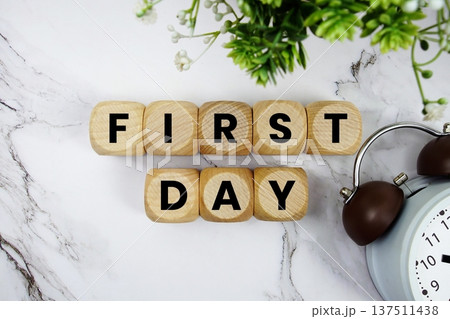 First Day alphabet letters and alarm clock on marble background First Day alphabet letters and alarm clock on marble background 137511438