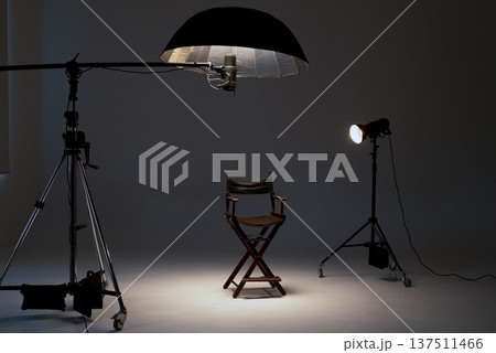 Professional photo studio setup with a director's chair, studio lights, softbox, flash on a boom Professional photo studio setup with a director's chair, studio lights, softbox, flash on a boom 137511466