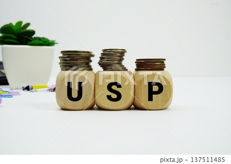 Stack of coins with wood blocks with "USP (Unique Selling Point)" Financial concept 137511485