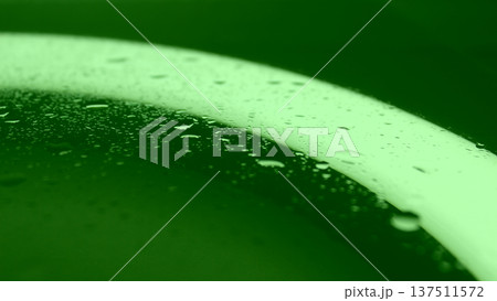 Texture of splashed water on green illuminated glass surface. Chroma Key Droplet Texture Background  137511572
