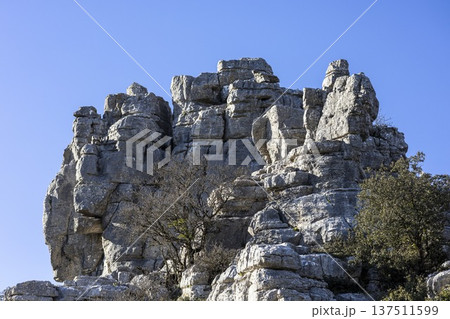 Exploring rock formations in El Torcal, Spain during a clear sunny day Exploring rock formations in El Torcal, Spain during a clear sunny day 137511599
