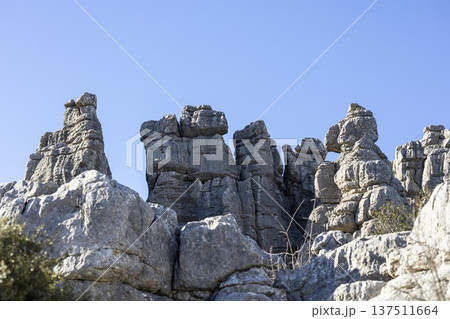 Exploring rock formations at El Torcal in Spain on a clear day in nature Exploring rock formations at El Torcal in Spain on a clear day in nature 137511664