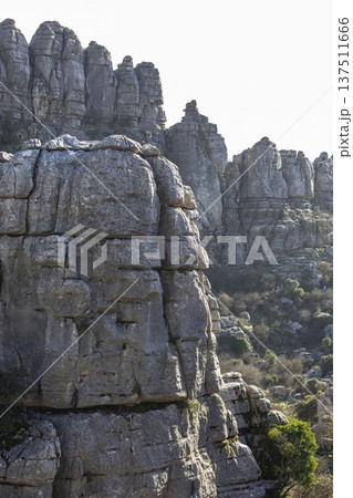 Exploring the rock formations at El Torcal in Spain during daylight hours with a view of the landscape and textures of the rocks Exploring the rock formations at El Torcal in Spain during daylight hours with a view of the landscape and textures of the rocks 137511666