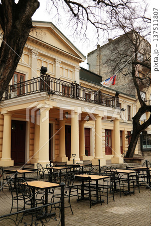 Historic theater building with columns and Serbian flag in Sombor, Serbia. Classical architecture and cultural heritage travel concept in European old town 137511807
