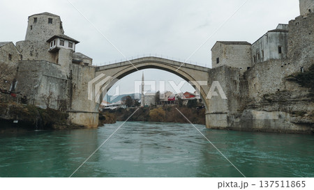 Iconic Stari Most bridge in Mostar spanning the turquoise Neretva River. Historic stone architecture reflects the cultural heritage and resilience of Bosnia and Herzegovina Iconic Stari Most bridge in Mostar spanning the turquoise Neretva River. Historic stone architecture reflects the cultural heritage and resilience of Bosnia and Herzegovina 137511865