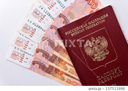 Russian Federation passport on five thousand ruble banknotes. Cash money and travel document flat lay 137511998