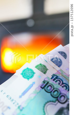 Heating payment. Save money wood stove. Russian ruble banknotes for payment of heating firewood. Heating payment. Save money wood stove. Russian ruble banknotes for payment of heating firewood. 137512096