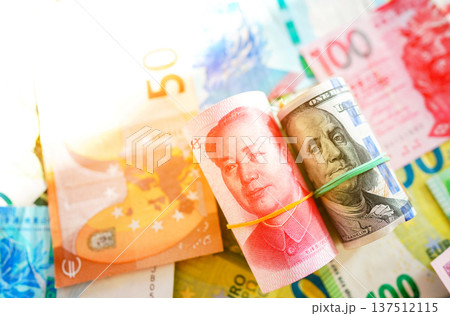 Chinese yuan, US dollars among various currencies background. Banknotes different countries Chinese yuan, US dollars among various currencies background. Banknotes different countries 137512115