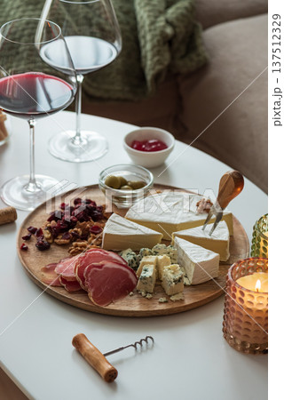 Charcuterie Board with Red Wine. Elegant Gourmet Gathering Charcuterie Board with Red Wine. Elegant Gourmet Gathering 137512329