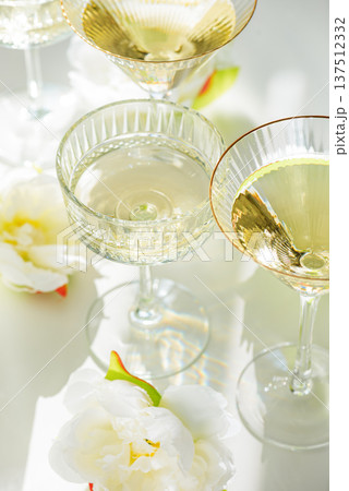 Champagne Glasses with White Peonies. Birthday or Wedding Celebration Arrangement. Top view 137512332