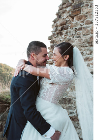 Groom lifting and hugging bride. Groom lifting and hugging bride. 137512353