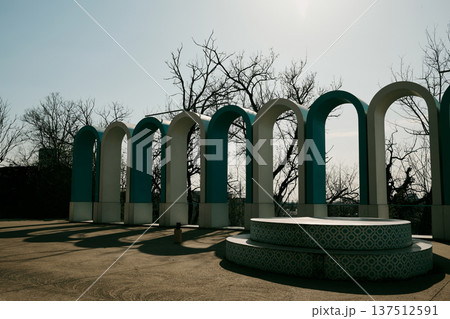 Modern urban installation with repeating arches forming geometric rhythm. Contemporary structure located in a public park space in Belgrade 137512591