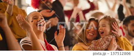 Excited football fans, supporting German national team in live soccer match at stadium. 137512806