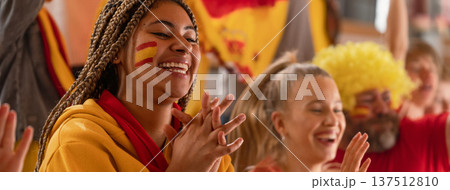Excited football fans supproting spanish national team in live soccer match at stadium. Excited football fans supproting spanish national team in live soccer match at stadium. 137512810