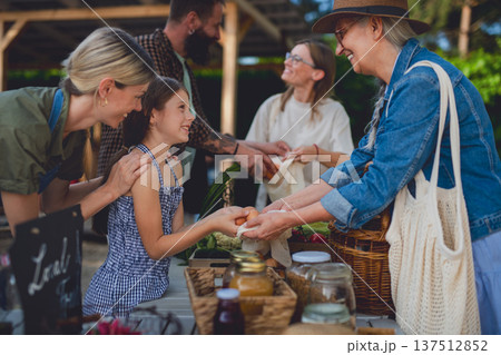 Buying organic produce and eggs at local farmers market. Buying organic produce and eggs at local farmers market. 137512852