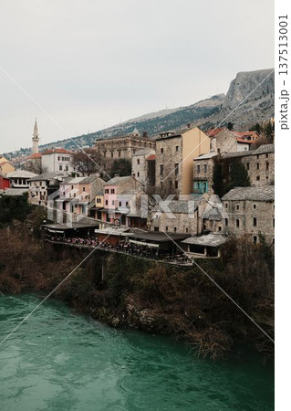 Old town of Mostar with mosque, minaret, historic houses, and turquoise Neretva River. Cultural Balkan cityscape representing history, religion, and travel heritage Old town of Mostar with mosque, minaret, historic houses, and turquoise Neretva River. Cultural Balkan cityscape representing history, religion, and travel heritage 137513001