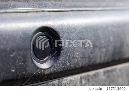 Parking sensors are mounted on the back of a vehicle. They help drivers detect obstacles when backing up or parking 137513602