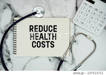 Reduce Health Costs text written on notepad with stethoscope and  calculator on marble background 137513711