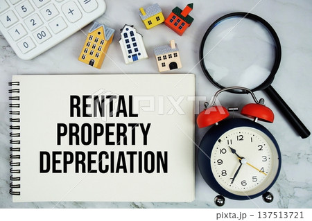 Rental Property Depreciation text written on notepad with house model, magnifying glass and alarm clock on marble background Rental Property Depreciation text written on notepad with house model, magnifying glass and alarm clock on marble background 137513721