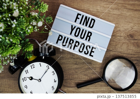 Find Your Purpose text in lightbox with magnifying glass and alarm clock flat lay on wooden background Find Your Purpose text in lightbox with magnifying glass and alarm clock flat lay on wooden background 137513855