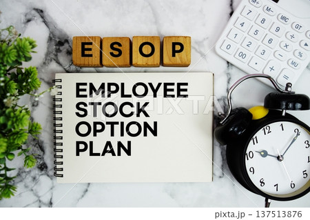 ESOP Employee Stock Option Plan text with calculator and alarm clock on marble background ESOP Employee Stock Option Plan text with calculator and alarm clock on marble background 137513876