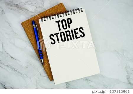 Top Stories text written on notepad with pen on marble background 137513961