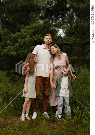 Joyful Family Captures Outdoor Happiness. Sunlit Family Reunion Amidst Blooming Wildflowers Joyful Family Captures Outdoor Happiness. Sunlit Family Reunion Amidst Blooming Wildflowers 137513966