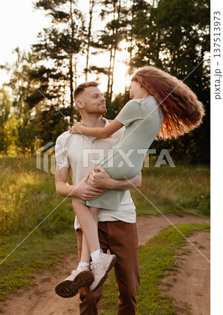 Father And Daughter Spinning Happily. Loving Father Twirling Daughter In Shining Field Father And Daughter Spinning Happily. Loving Father Twirling Daughter In Shining Field 137513973