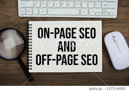 On-Page and Off-Page SEO text written on notepad with keyboard, optical mouse and magnifying glass on wooden background; 137514002