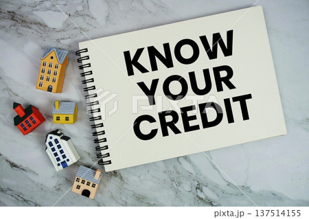 Know Your Credit text written on notepad with house model on marble background Know Your Credit text written on notepad with house model on marble background 137514155