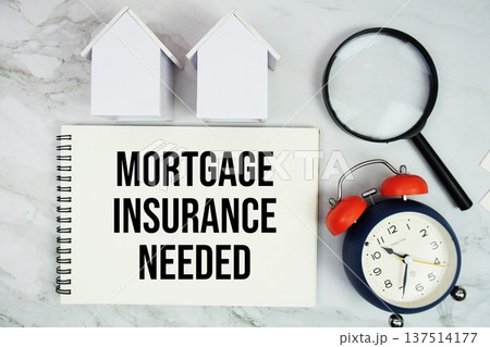 Mortgage Insurance Needed text written on notepad with house model, magnifying glass and alarm clock on marble background 137514177