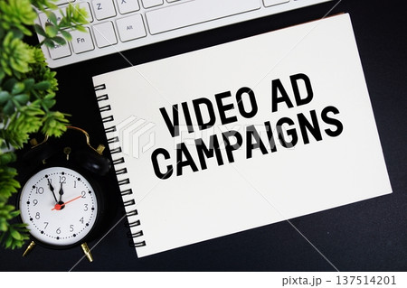 Video Ad Campaigns text written on notepad with keyboard and alarm clock on black background Video Ad Campaigns text written on notepad with keyboard and alarm clock on black background 137514201