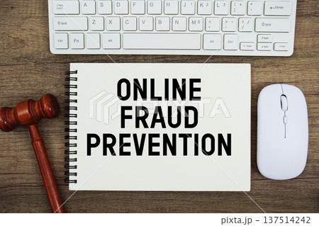 Online Fraud Prevention text written with gavel, keyboard and optical mouse on wooden background 137514242