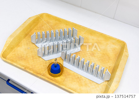 laboratory equipment. plastic tube racks on a yellow plastic tray. 137514757