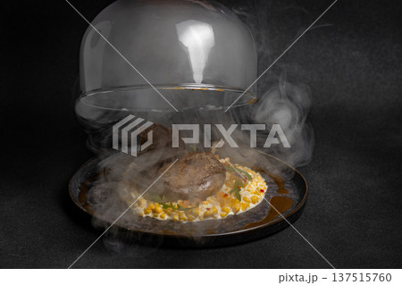 Duck leg with risotto, pumpkin and herbs on a dark background Duck leg with risotto, pumpkin and herbs on a dark background 137515760