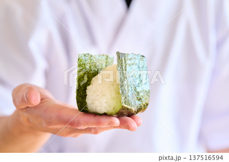 おにぎりに海苔を巻く料理人 137516594