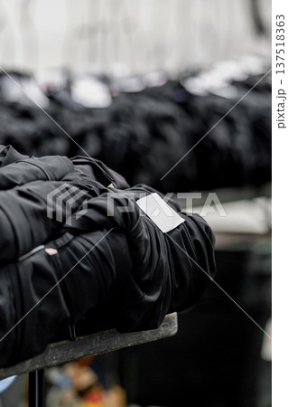 Rows of graduation gowns organized for an upcoming university ceremony in England, reflecting classic academic tradition and celebration. 137518363