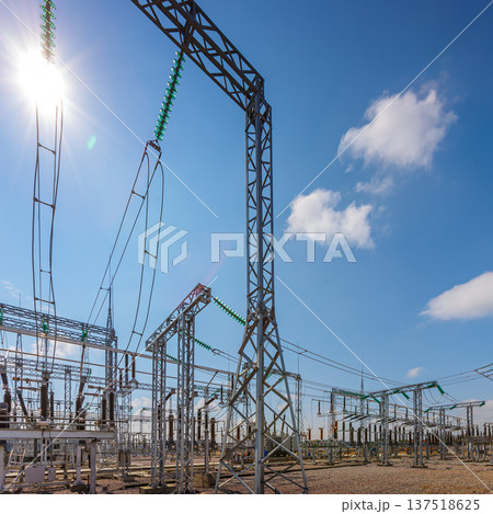 Panoramic view of an outdoor electrical distribution substation, without people, at daytime on a background of a clear blue sky Panoramic view of an outdoor electrical distribution substation, without people, at daytime on a background of a clear blue sky 137518625