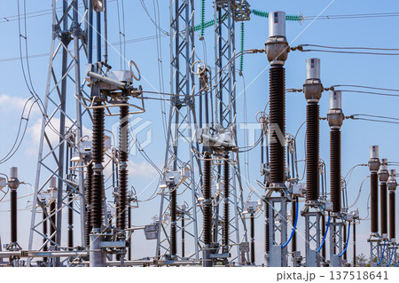 Panoramic view of an outdoor electrical distribution substation, without people, at daytime on a background of a clear blue sky 137518641