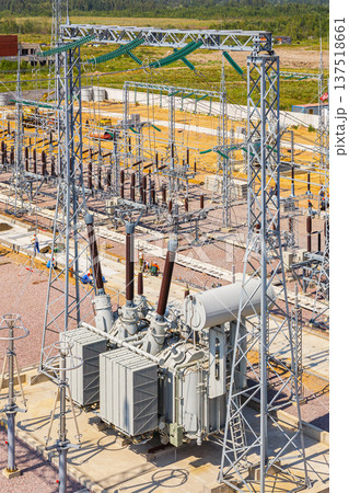 vertical aerial view of a power transformer installed at an electrical substation, without people, during daytime 137518661