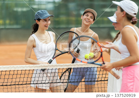 Girls chat on court between tennis games 137520919
