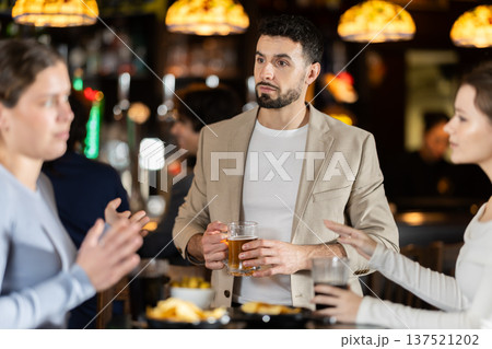 Young man flirting with two women getting rejected 137521202