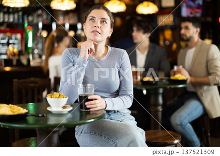 Young woman spending time alone at bar 137521309