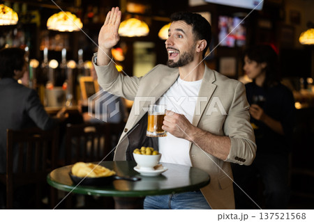 Man sitting in bar and watching game 137521568