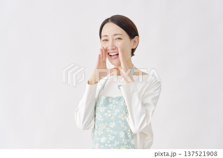 話しかけるエプロンを着た女性　白背景 137521908